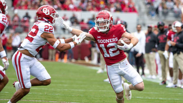 Oklahoma Red Team's Drake Stoops (12) stiff arms Oklahoma White Team's Peyton Bowen (22) during a spring scrimmage game at Gaylord Family Oklahoma Memorial Stadium in Norman Okla., on Saturday, April 22, 2023.